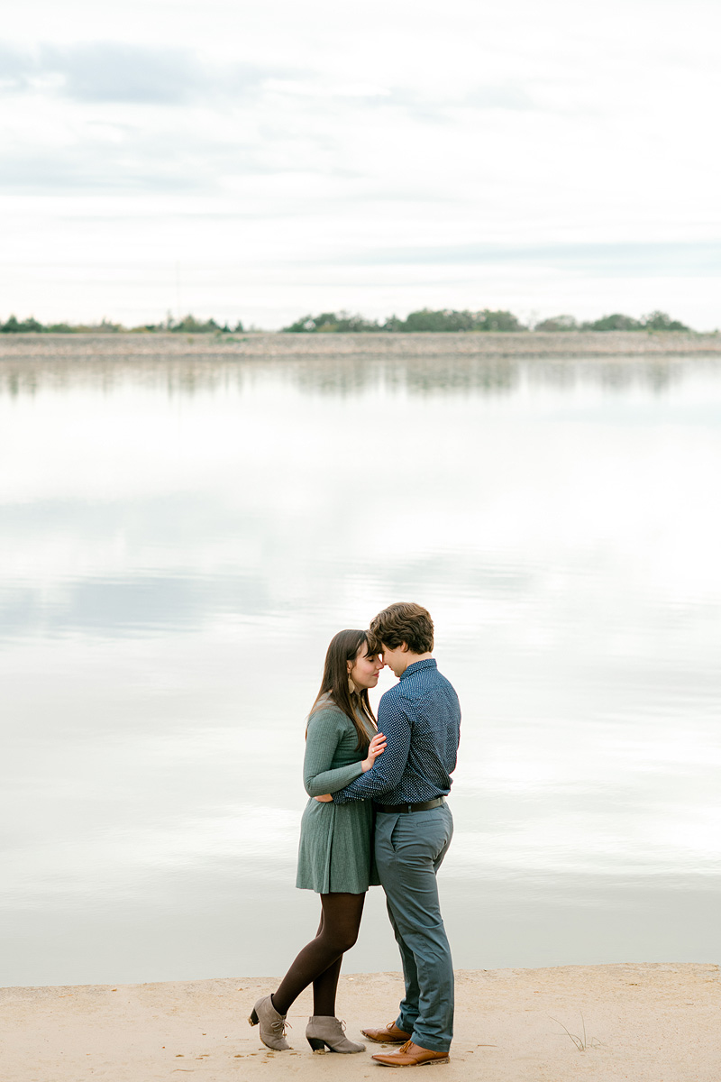 Engaged couple wearing green & blue at Lake Bryan
