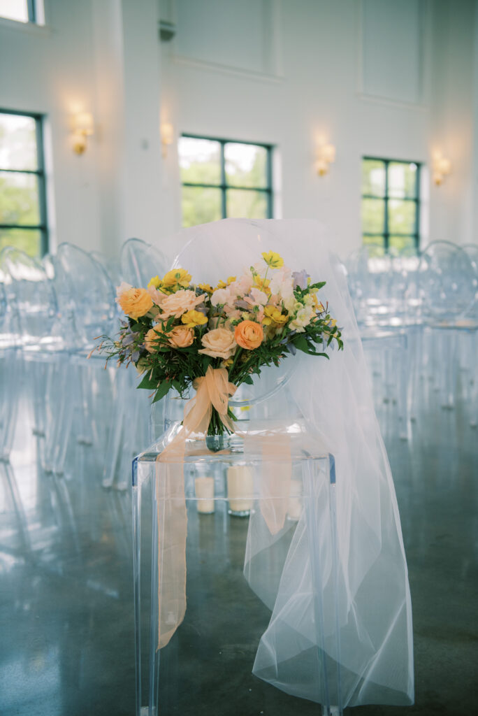 Bridal Bouquet in shades of orange, peach, and yellow at Houston Venue Boxwood Manor