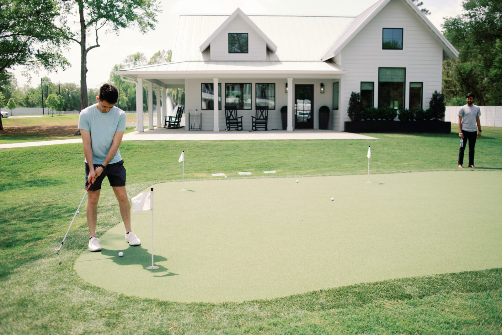 Playing putt putt golf at Houston Venue Boxwood Manor 