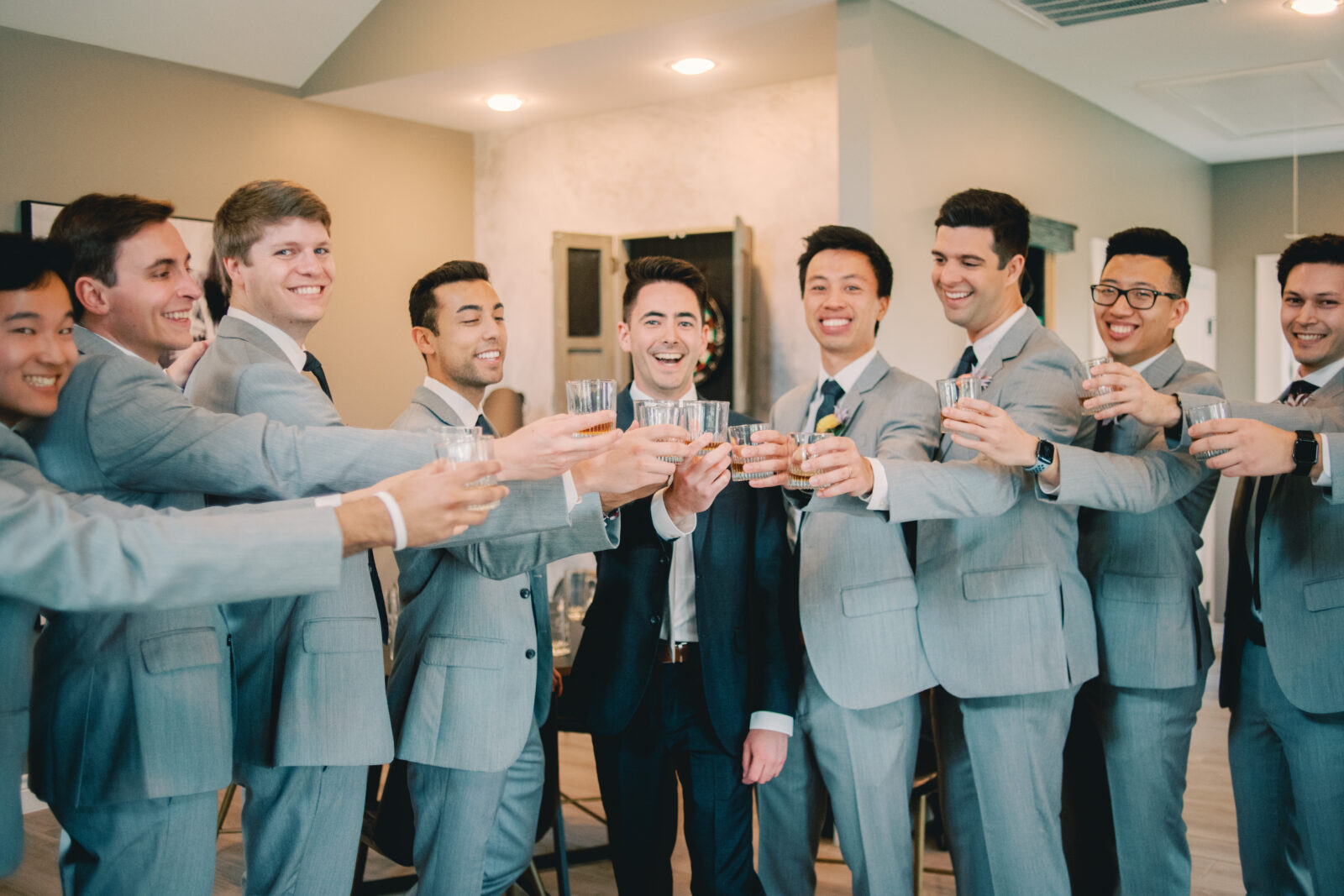 Groomsmen share a toast at Houston Venue Boxwood Manor by Mercie B Studio